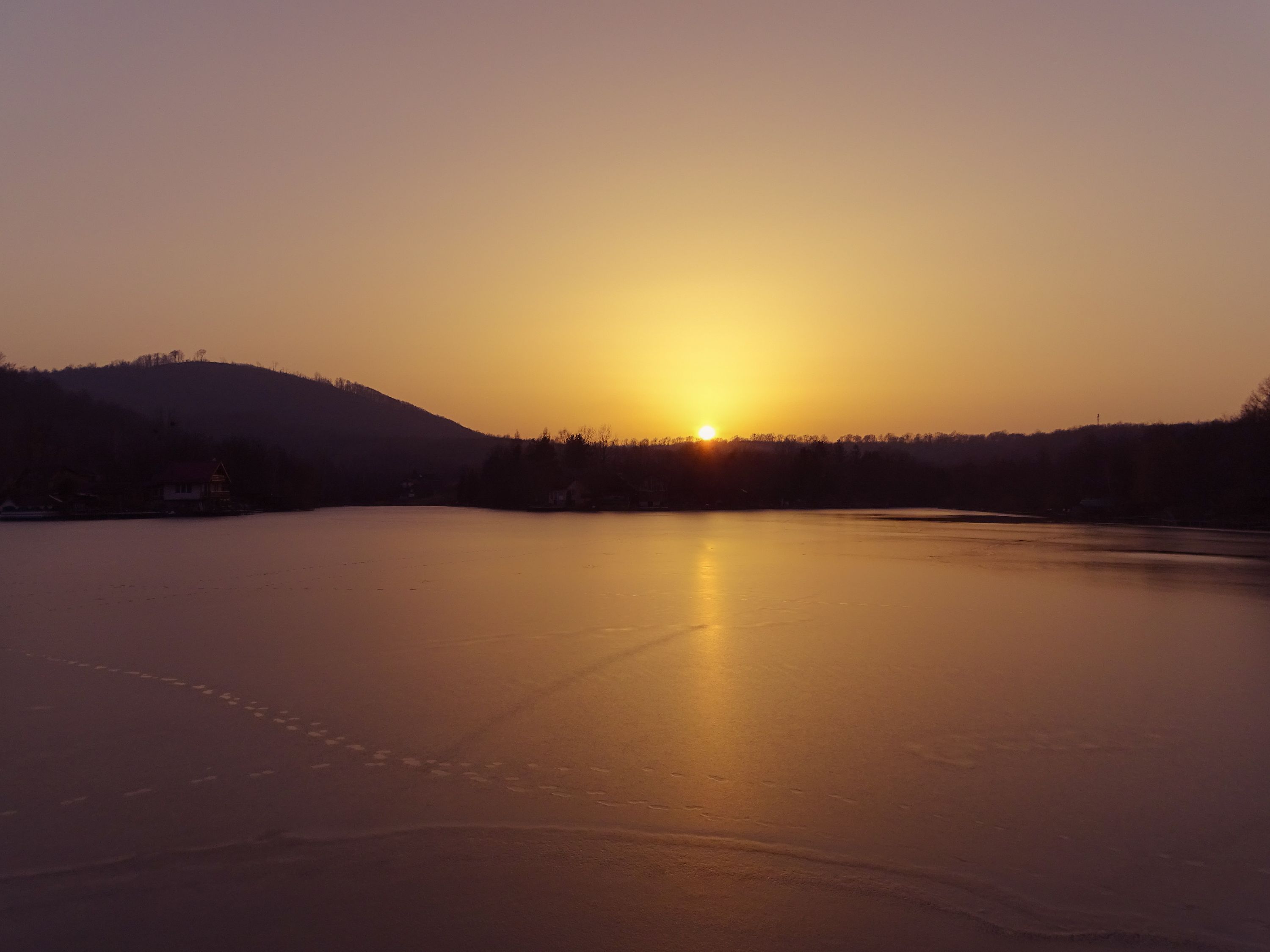 Sunset over frozen lake