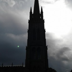 Dark sun and church tower.